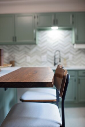 A dining table with chairs in a kitchen area. - Cozy Camp Greene Retreat | Near Uptown Charlotte (Charlotte)