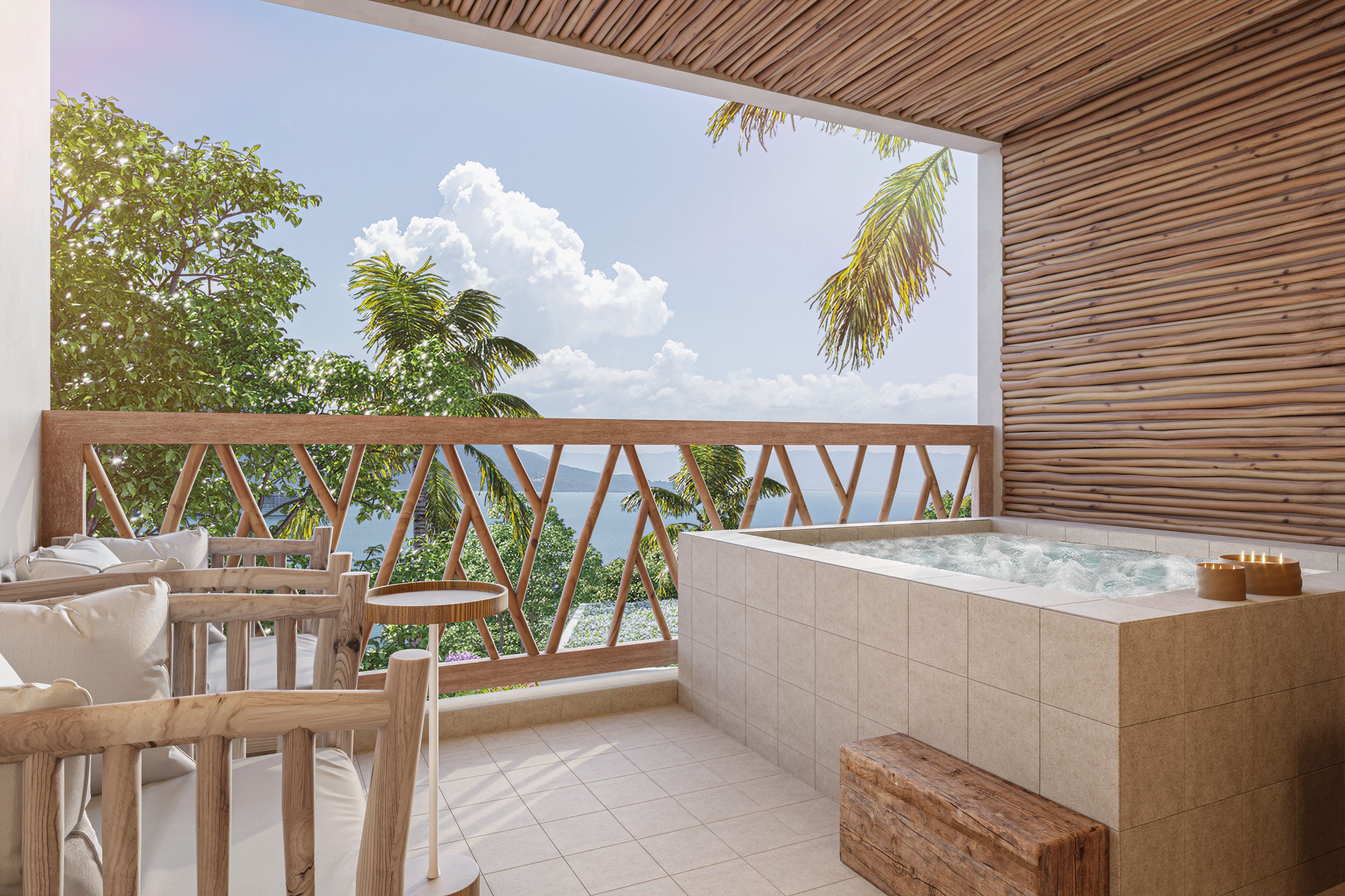 Un balcon avec une balustrade en bois, un jacuzzi et une vue sur la mer et les arbres.