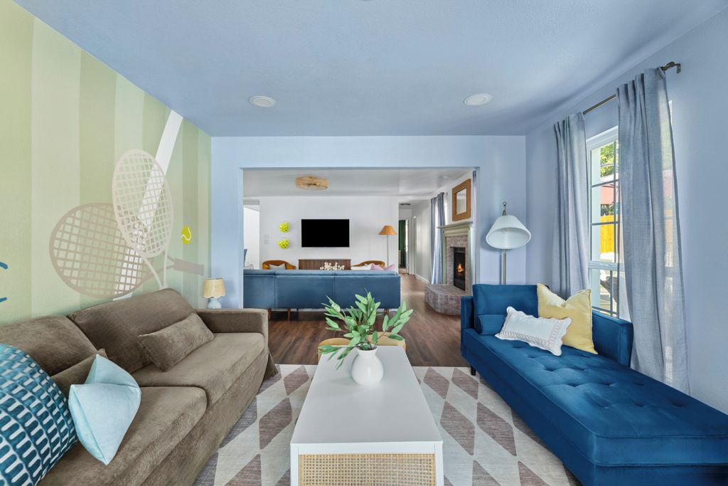 A modern living room with a sofa, a coffee table, and a television.