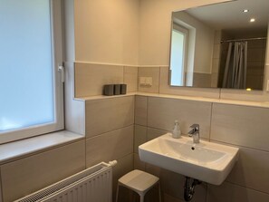A bathroom with a window, a white sink, and a mirror. - Holiday Home With 4 Bedrooms (Braunlage)