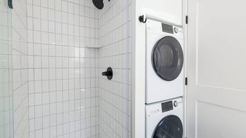 Full bathroom w/ walk in shower and laundry area