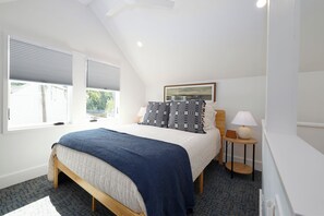 Spacious loft bedroom with lots of natural light and a queen bed