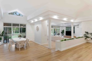 Bright causal dining space positioned underneath a high vaulted ceiling with natural light flowing through large windows. - The Oak Estate | Acreage Retreat with Pool (Nerang)