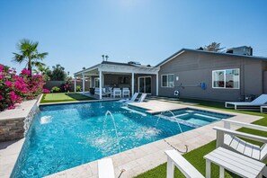 A swimming pool with a patio area, lounge chairs, and a covered seating area. - Scottsdale Retreat | Pool, HotTub, PutPut, Grill (Scottsdale)