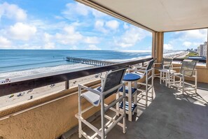 A balcony with a view of the beach and pier, featuring outdoor seating. - 3BR Oceanfront Escape - Cherry Grove Views (North Myrtle Beach)