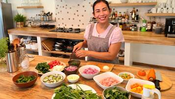 A kitchen counter with various ingredients and kitchen utensils.