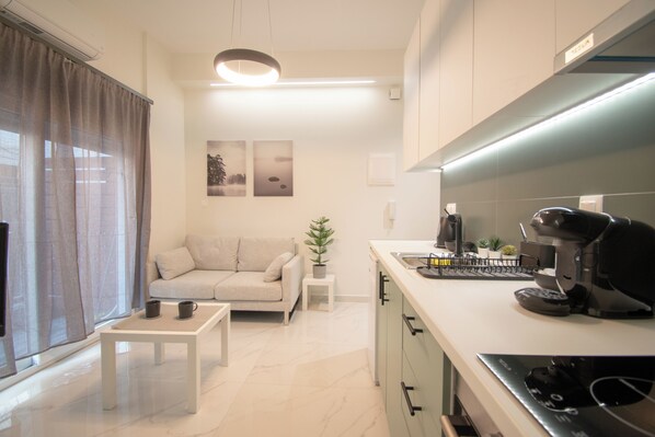 A modern living room with a sofa, coffee table, and a small plant.