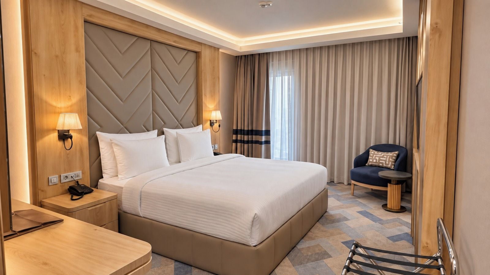 A hotel room with a large bed, bedside lamps, a desk, and a chair.