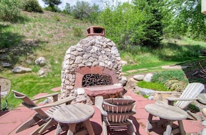 A stone-built outdoor fireplace with seating. - Kiva Ski In 2BD/3BA Condo w/ Resort Pool & Hot Tub (Beaver Creek)