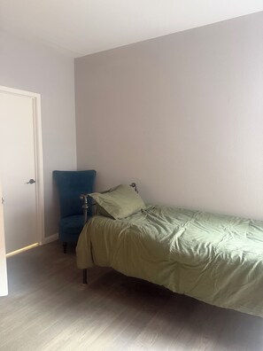 A bedroom with a single bed, a chair, and a door. - 2-bed, 2-bath condo, guard-gated, pool, spa, and fitness center. (Las Vegas)
