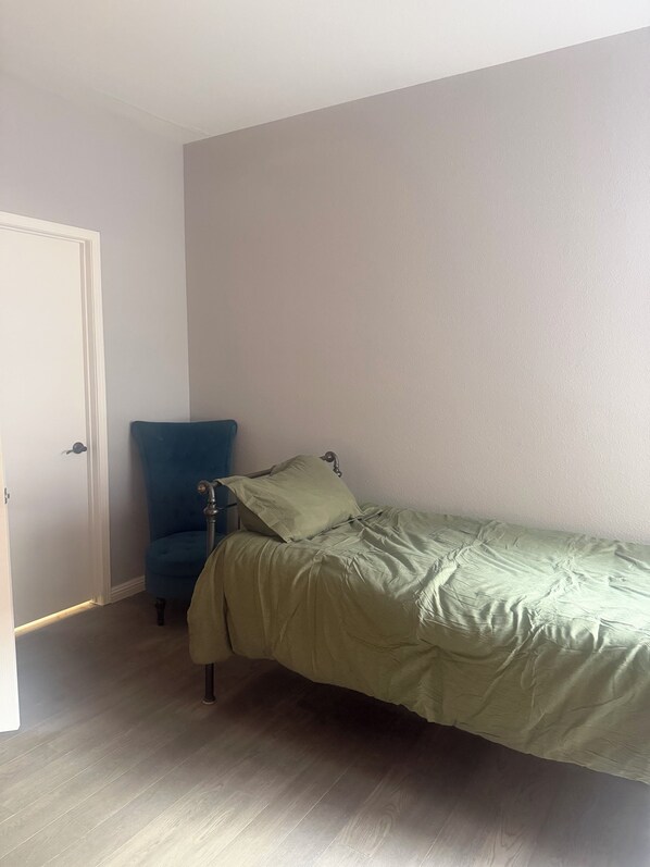 A bedroom with a single bed, a chair, and a door. - 2-bed, 2-bath condo, guard-gated, pool, spa, and fitness center. (Las Vegas)