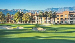 A golf course with multiple buildings in the background, a clear sky, and mountains in the distance. - Large Stagecoach Getaway Guest Room at Beautiful Marriott Shadow Ridge Resort (Palm Desert)