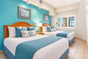 A hotel room with two beds, a window with shutters, and artwork on the walls. - Beach Cove Resort 308 (North Myrtle Beach)
