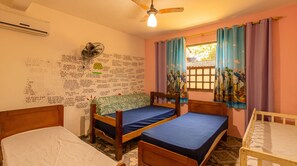 A room with two wooden beds, a ceiling fan, and a window with curtains. - House with Pool and BBQ in Rio Escuro (Ubatuba)