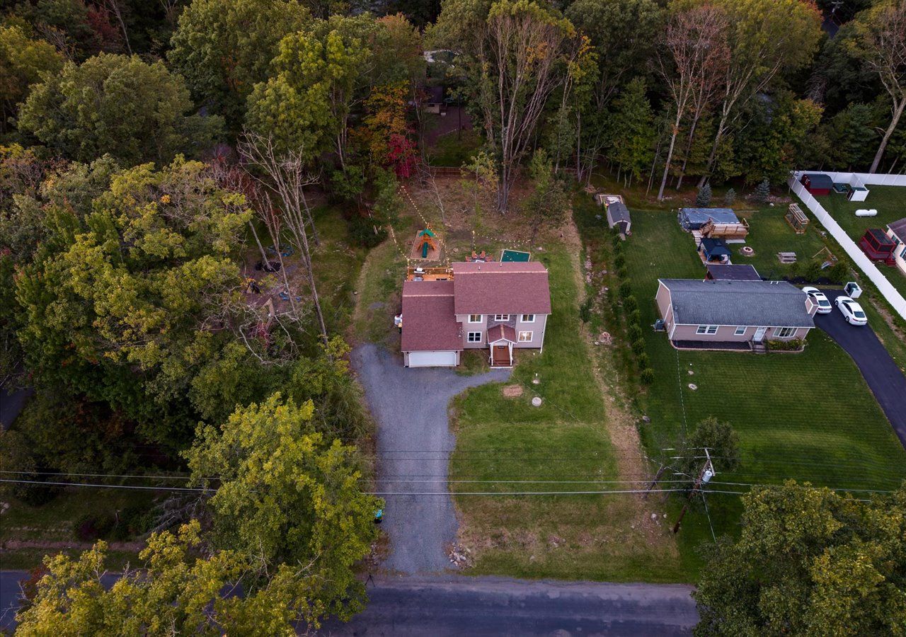 A residential area with a house, a driveway, and a lawn.