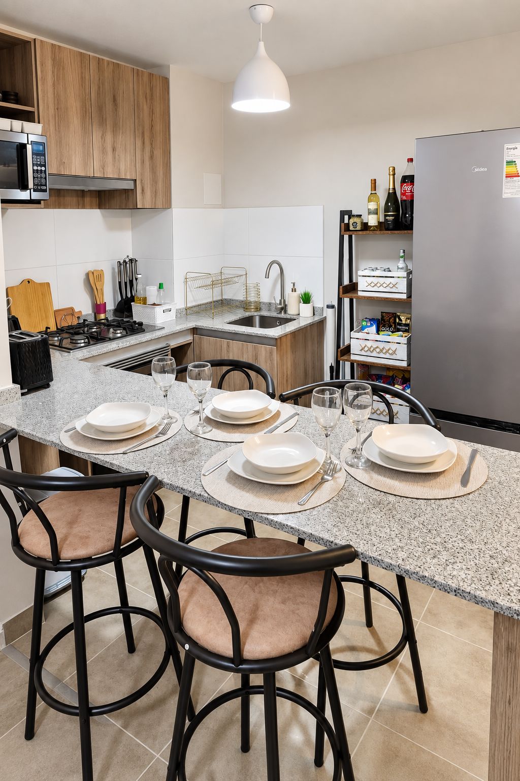 A modern kitchen with a central island, stainless steel appliances, and a built-in refrigerator.