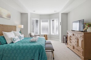 A bedroom with a bed, a dresser, a television, and a window with blinds. - Coastal Escape w/ Putting Green, Pool, + Hot Tub (Hilton Head Island)