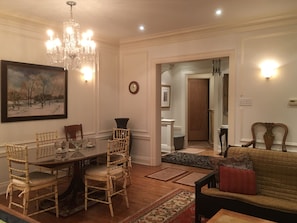 A dining area with a chandelier, a painting, and a dining table with chairs. - 2-bedroom apartment in marvelous Chicago lakefront with  AC (Chicago)
