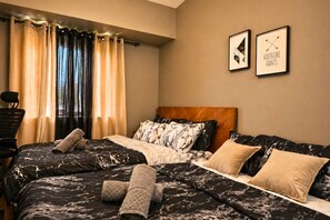 A hotel room with a bed, two pillows, a headboard, a window with curtains, and two framed pictures on the wall. - PS4+Netflix, 100Mbps WiFi & Workstation inside IT Park (Cebu City)