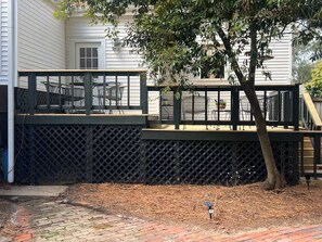 A deck with outdoor furniture, a tree, and a brick pathway leading to a house. - Historic Cottage near MSU, Old Waverly & Mossy Oak (West Point)