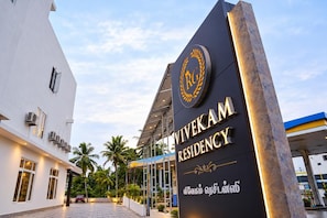 A hotel entrance with a sign reading 'Viveka Residency' and a logo above it.