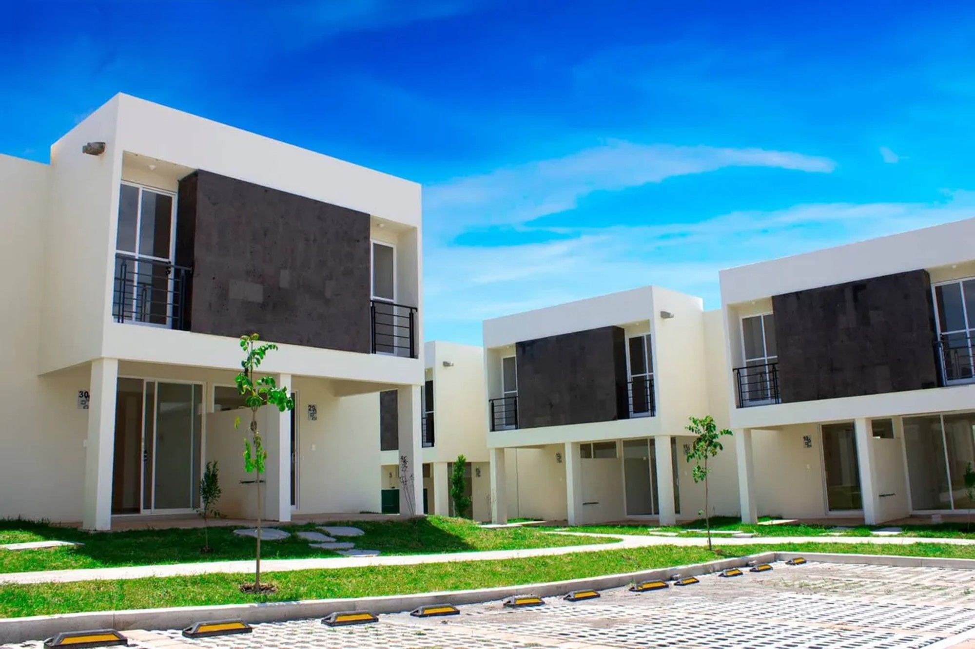 A modern building with a flat roof, large windows, and a clean, minimalist design.
