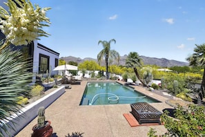A pool area with a modern house, outdoor furniture, and desert plants. - Tucson: Catalina Foothills Retreat (Tucson)