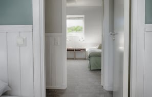 A bedroom with a bed, bedside tables, a window, and a door. - Beautiful home in Varberg with WiFi (Varberg)