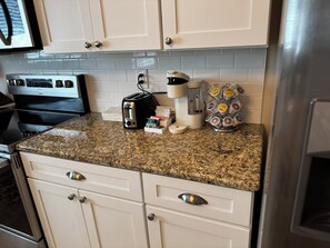 A kitchen with a granite countertop, a coffee maker, a toaster, and a coffee mug rack. - NEW Enjoyable 2-bedroom townhome in Twin Falls (Twin Falls)