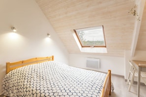 A bedroom with a bed, a desk, and a window. - Kargalan Vacation Rental - CRACH - Vacation Rental (CRACH)