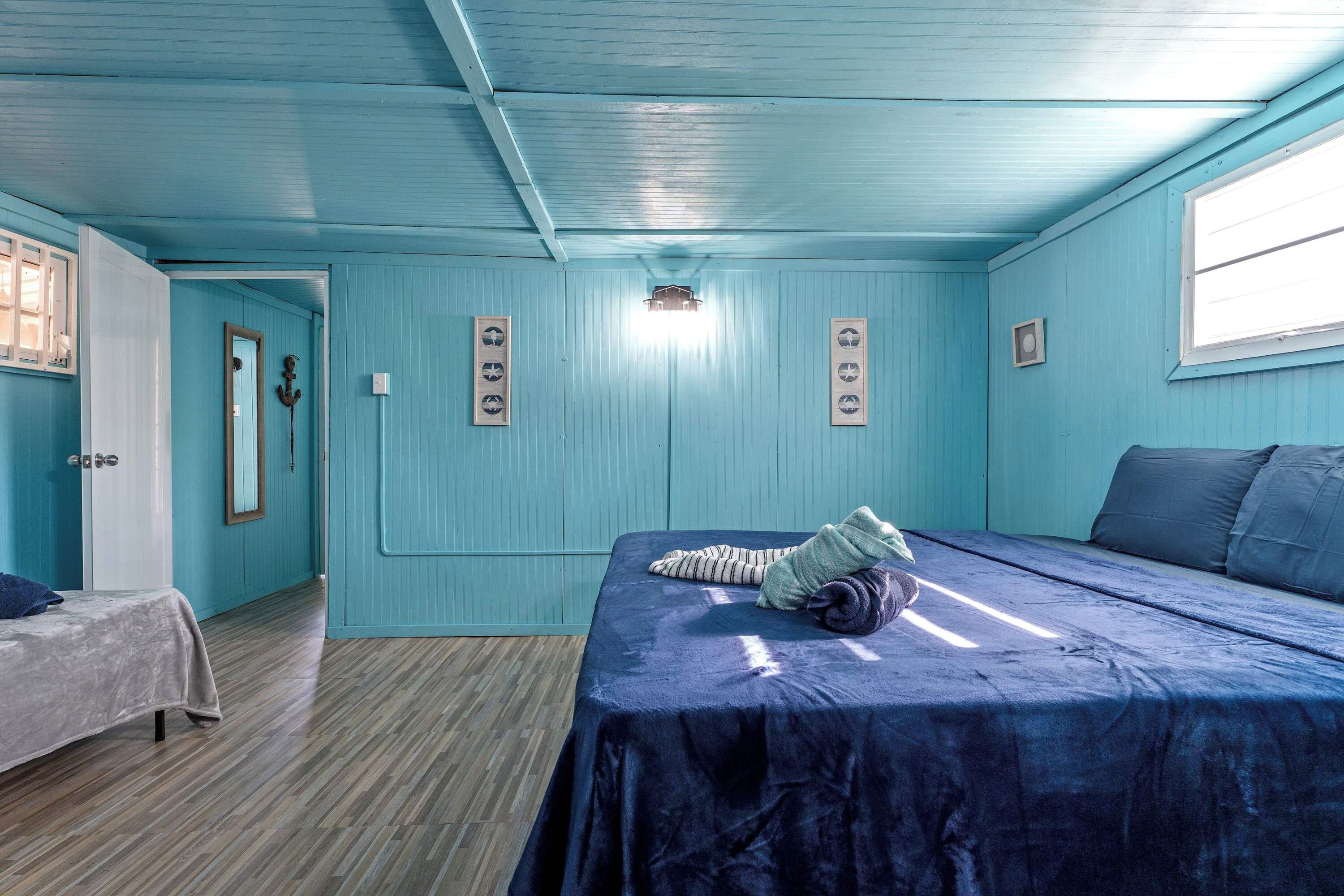 A room with a bed, a small table, and a window.