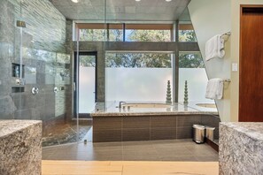 A modern bathroom with a glass-enclosed shower, a large bathtub, and a vanity with two sinks. - Stunning 9 Bedroom Golf Estate - 200 Feet Golf Frontage on Private Course (Rancho Mirage)