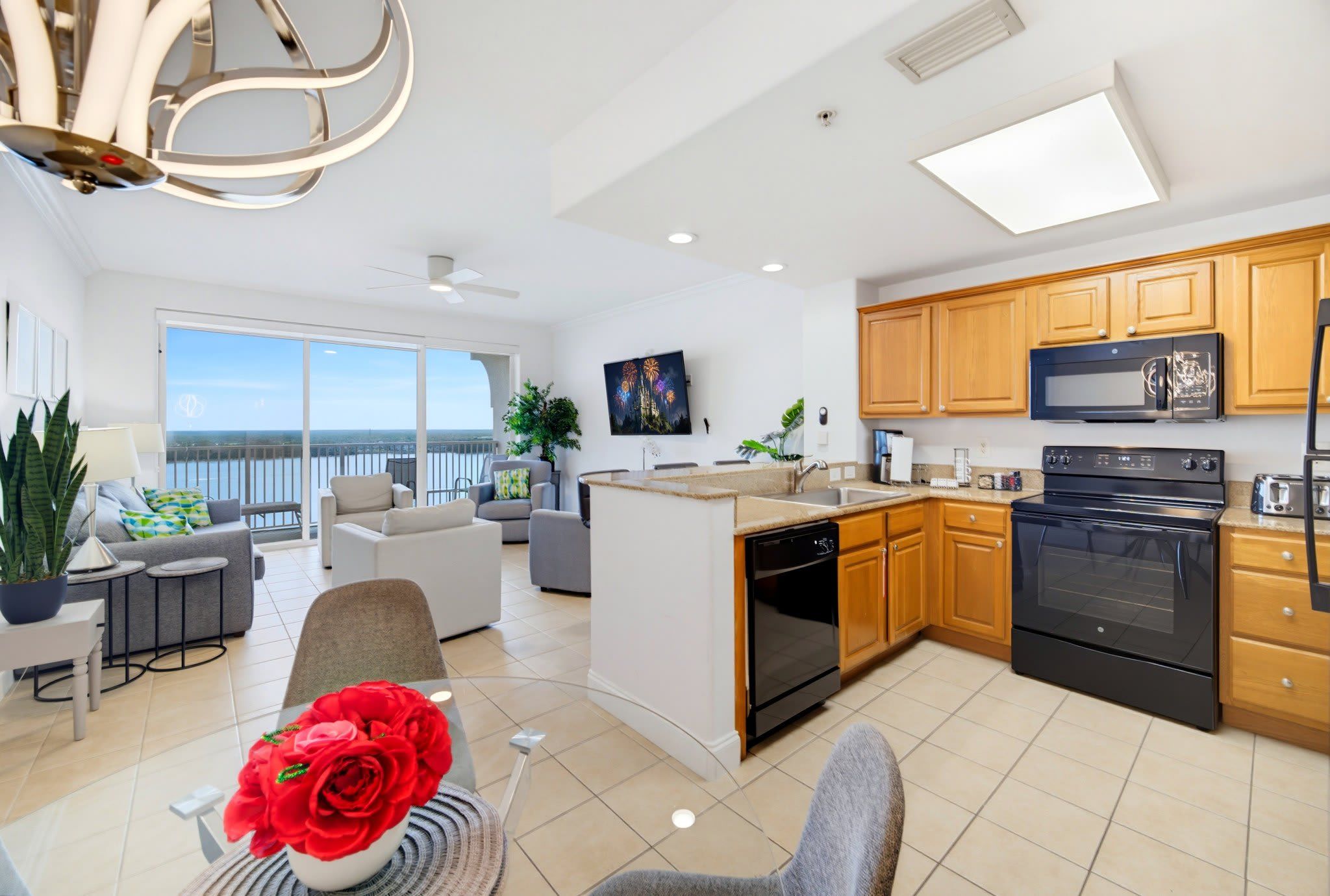 A modern kitchen with a central island, wooden cabinets, and stainless steel appliances.