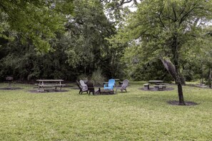 A picnic area with a table and chairs, surrounded by trees. - Amelia Island Retreat | Walk to Beach, Pool & Balcony (Fernandina Beach)