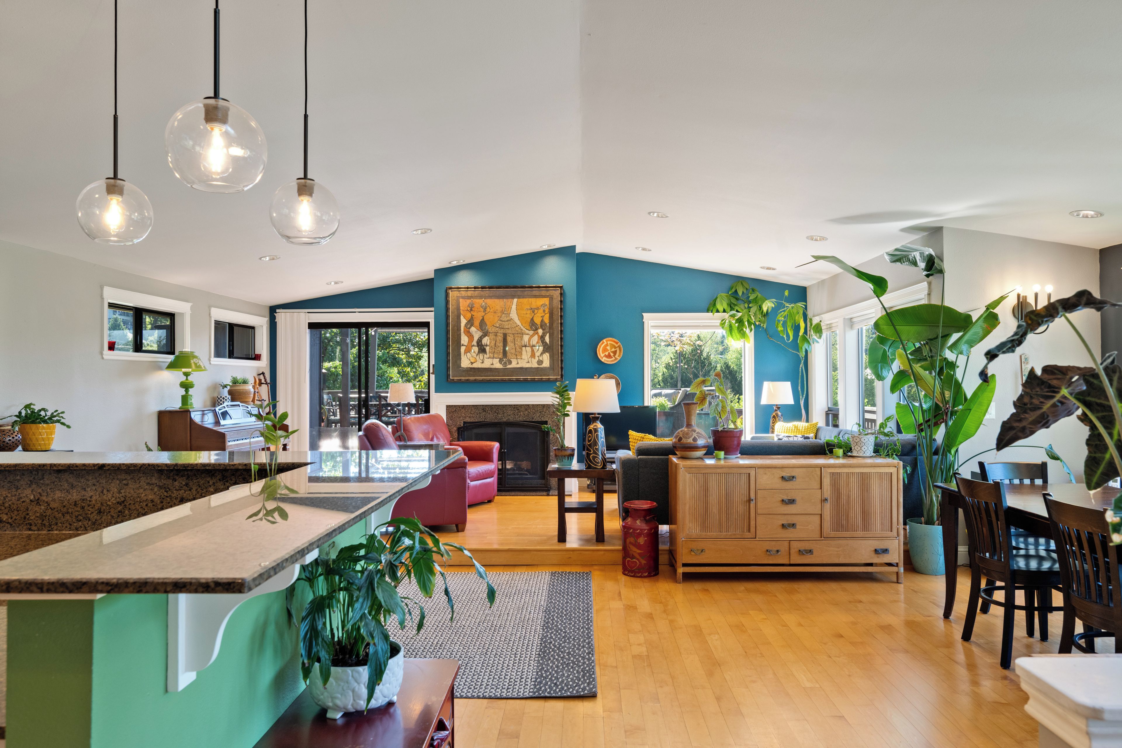 A spacious living area with a kitchen, dining space, and a fireplace.