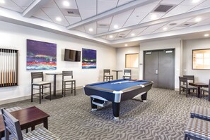 A pool table in a room with a carpeted floor, chairs, a television, and artwork on the walls. - Presidential Penthouse 3 Bdrm available 4 your Raiders vs. Rams Football game! (Las Vegas)
