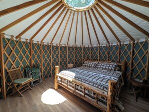 A tent with a bed, a chair, and a table. - Big Woods Retreat (Miramonte)