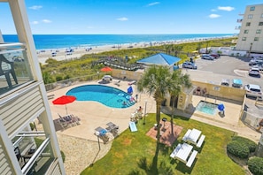 A hotel with a swimming pool, beach view, and a parking area. - A Place at the Beach - Windy Hill 308 - 2BR 2BA Condo North Myrtle Beach Pool & Hot tub (North Myrtle Beach)