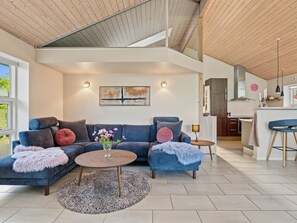 A modern living room with a sectional sofa, a coffee table, and a painting on the wall. - "Nelia" - 1km from the sea by Interhome (Væggerløse)