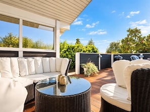 An outdoor patio with a sofa, chairs, and a table. - "Nelia" - 1km from the sea by Interhome (Væggerløse)
