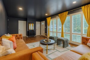 A living room with a sofa, armchairs, a coffee table, and a fireplace. - Peaceful 4BR Home Private Backyard Near DC & Old Town (Alexandria)