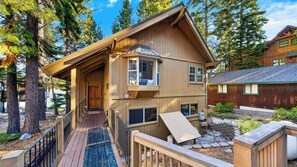 A two-story wooden cabin with a covered porch and a small deck. - Meeks Bay Chalet by Avantstay Lakefront Retreat Boat Dock + Hot Tub Near Beach (Tahoma)