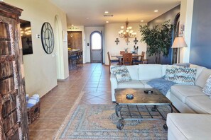 A spacious living area with a sofa, coffee table, and a patterned rug. - Elevated Bella Sirena Views: 2nd Floor Luxury (Puerto Peñasco)