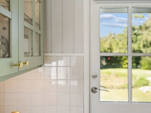 A white door with a window, a green cabinet with glass doors, and a tiled wall. - "Henryka" - 750m from the sea by Interhome (Gilleleje)