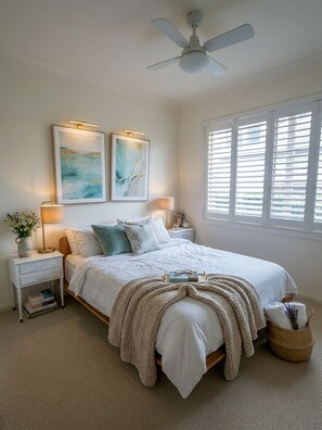 A bedroom with a bed, nightstands, wall art, a ceiling fan, and a window with blinds. - Avalon home flat 5 minute stroll to village (Avalon Beach)