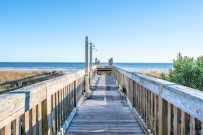 A wooden boardwalk leading to the beach with a clear sky above. - Stunning View Amazing Oceanfront on the 12th Floor (North Myrtle Beach)