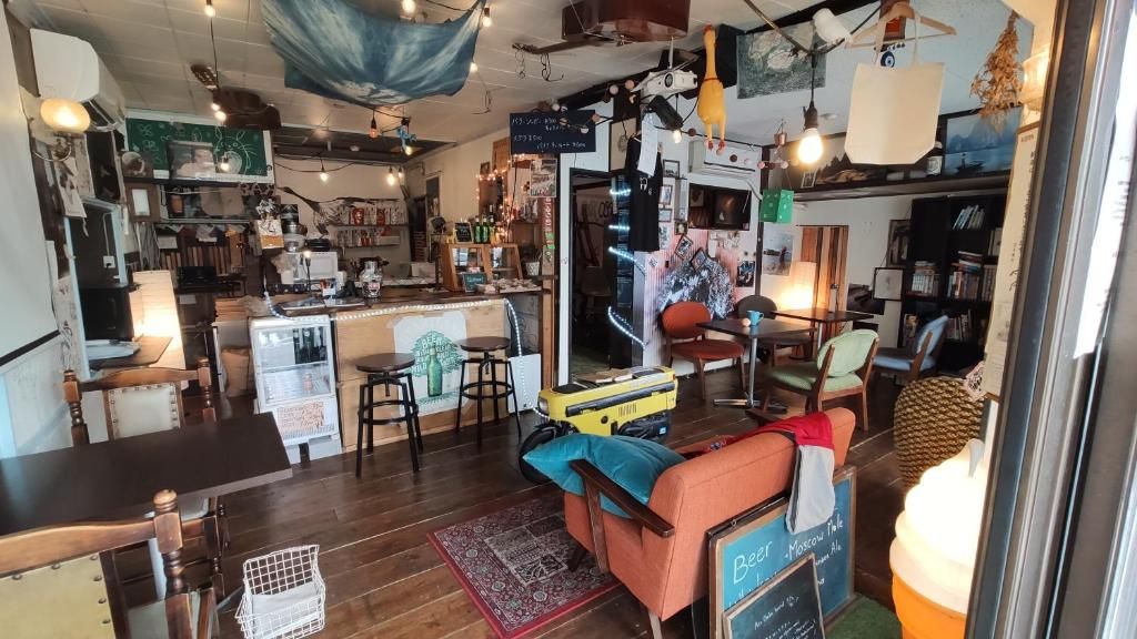Un ambiente acogedor con una zona de bar, asientos y un menú en pizarra.