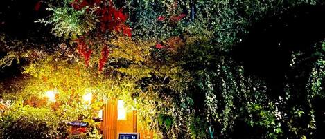 An outdoor seating area with a sign for the Air Osaka Hostel.