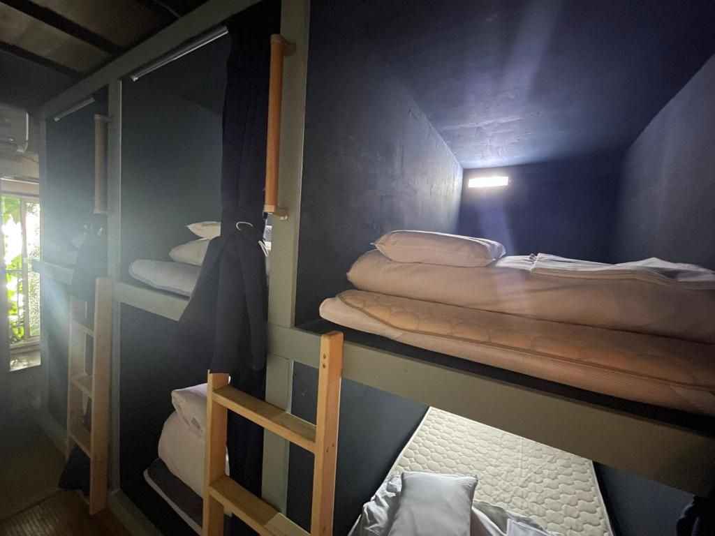 Una cama litera con escalera, colchón y almohadas.