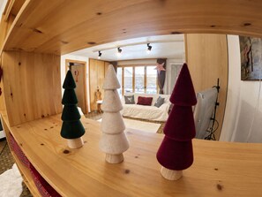 A wooden interior with three Christmas trees on a curved wooden shelf. - Residenz Albina Leukerbad # 4-bed apartment, Dusche, WC by Interhome (Leukerbad)